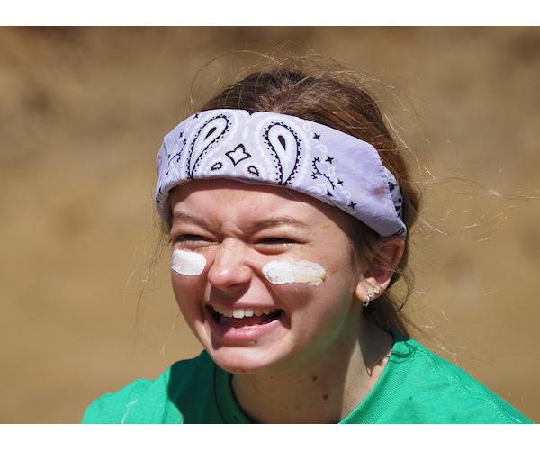 Student with bandana smiling playing oozeball.